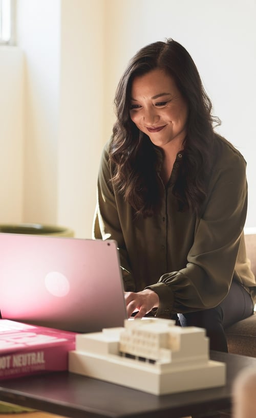 Woman on computer smiling
