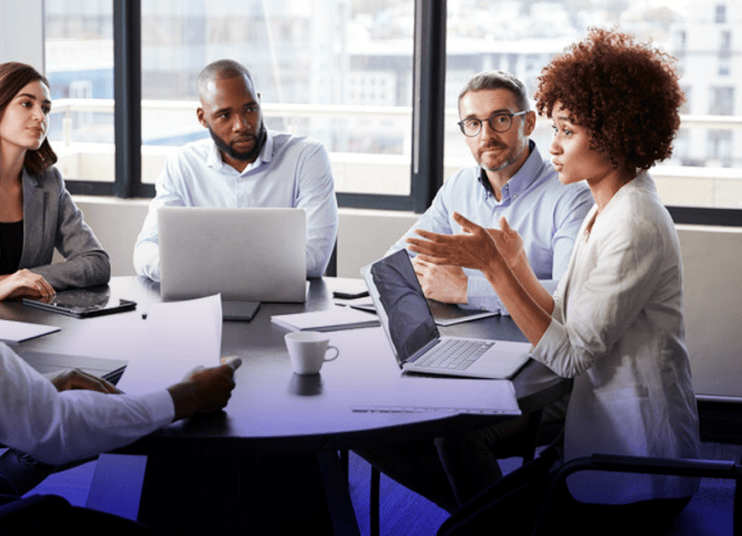 People sitting around conference table People sitting around conference table